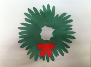 Kids handprints make a very cute twist on the usual Christmas wreath